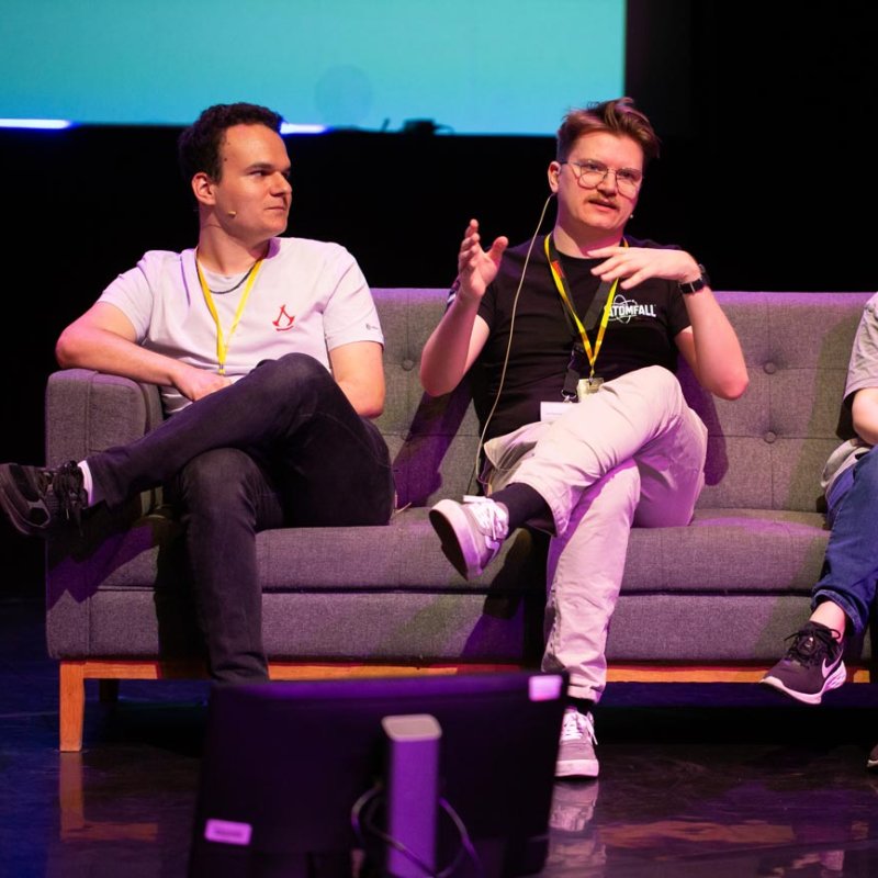 Three people on a sofa speaking at Falmouth University 2025 Games Expo