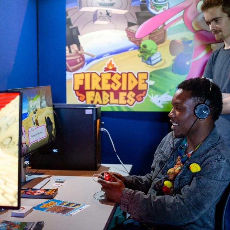 A man playing a computer game at Falmouth University's 2025 Games Expo