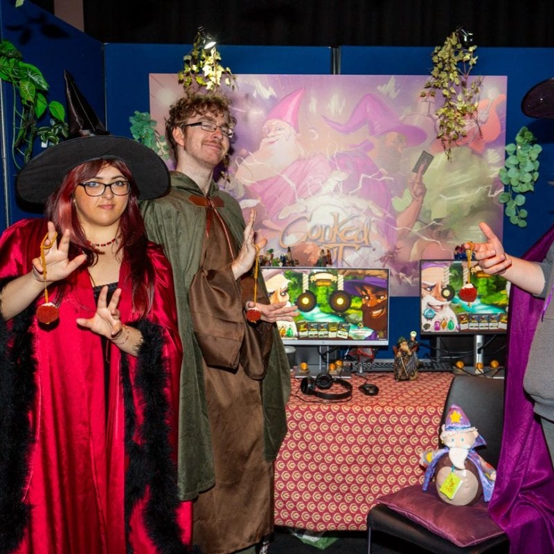 Three Falmouth University students dressed at wizards at the Games Expo 2025