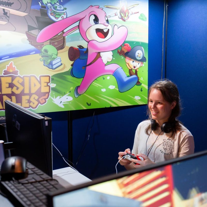 Two female students playing games at Falmouth University Games Expo