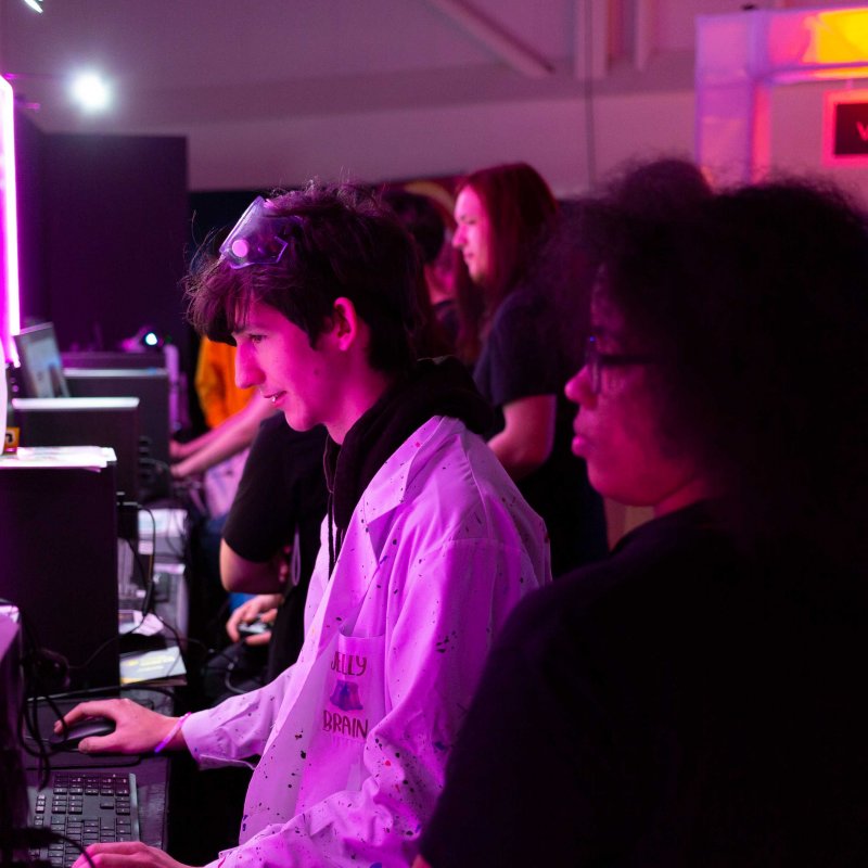 Students playing games on PCs at the 2022 Games Expo 