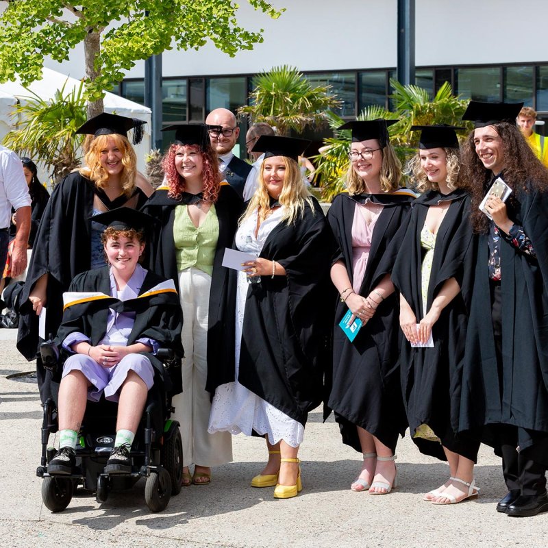 A group of students in gowns at Falmouth University's 2023 graduation