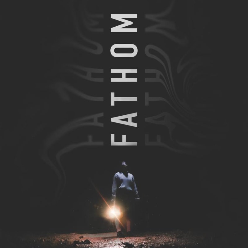 Film poster with the the title 'Fathom' placed vertically, with a person standing in the dark