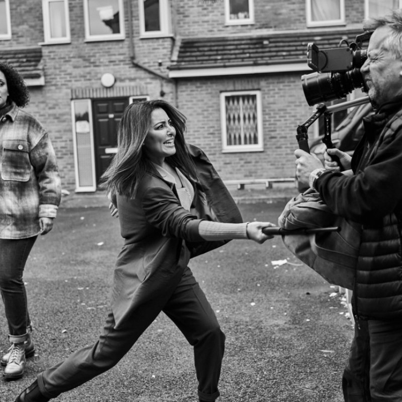 A woman strikes a camera operator with a bludgeon on the set of London Kills