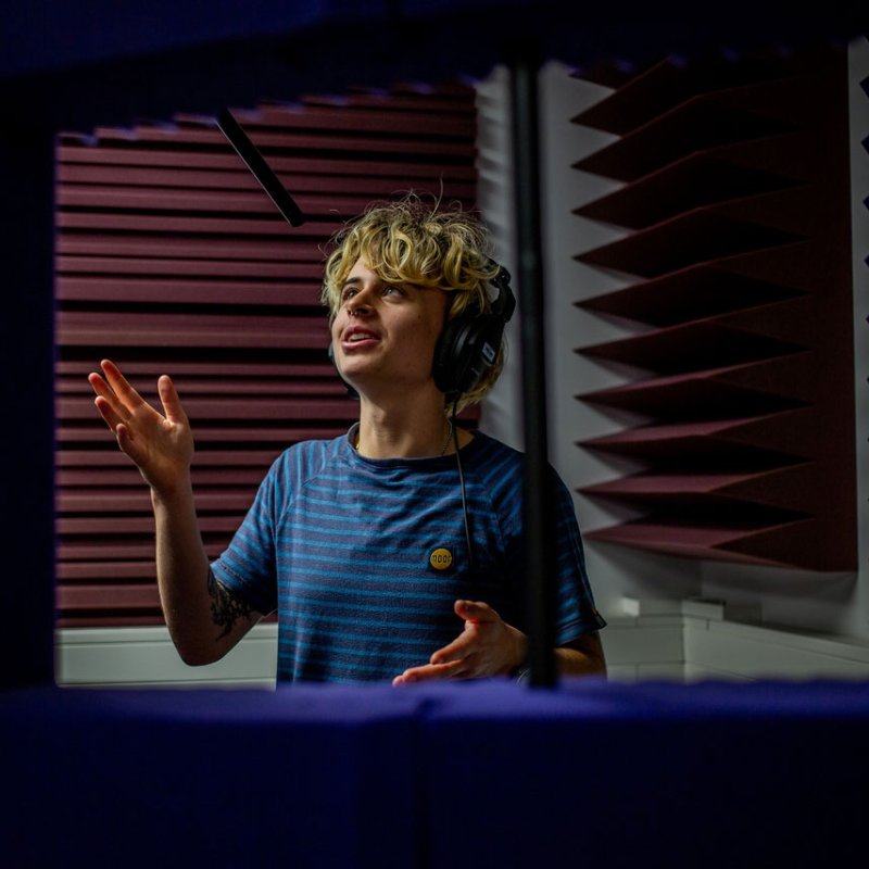 a Falmouth University Film student speaking and wearing headphones