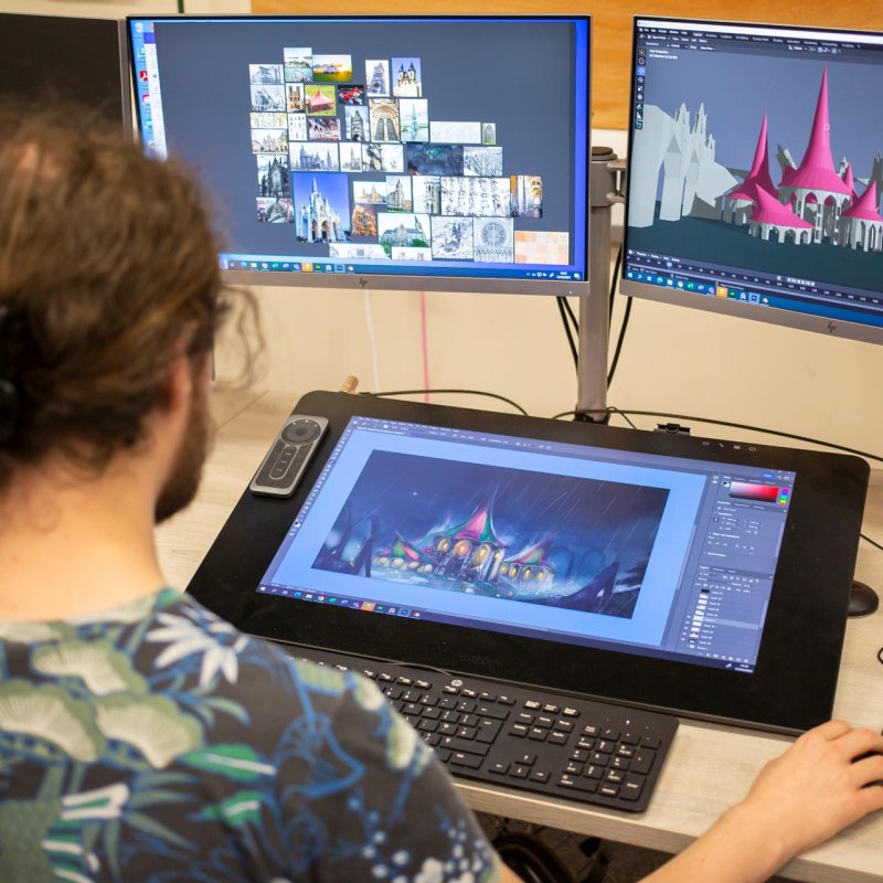 A man working on a game design of a castle