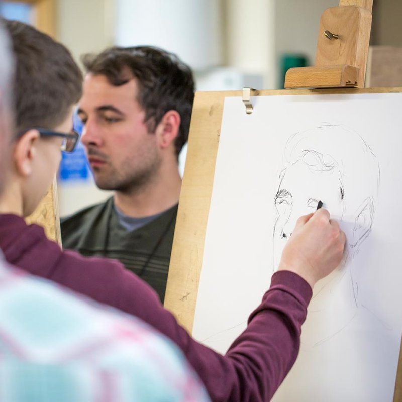 Game Art students drawing at an easel