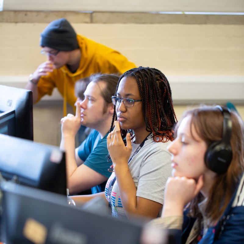 Four Falmouth University students at computers during the 2025 Games Jam