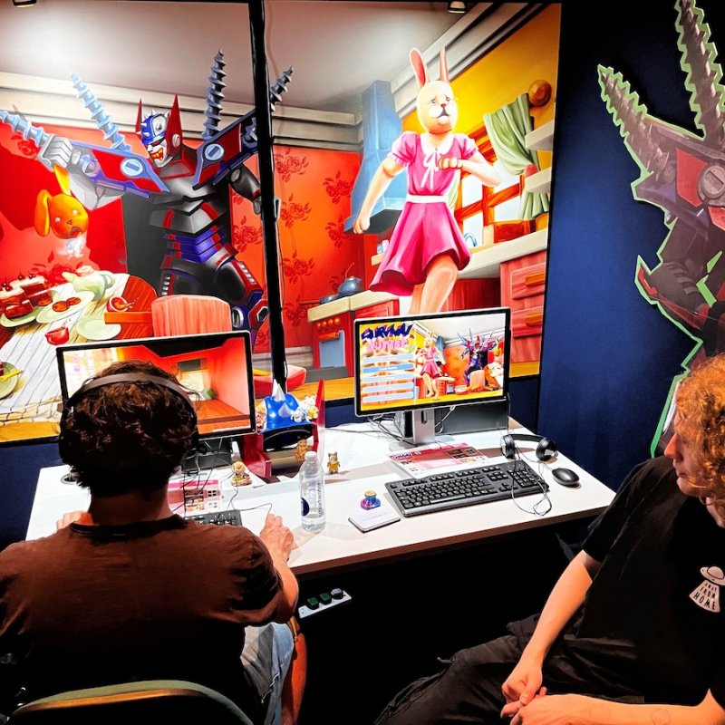 Two male students playing a game at Falmouth University's Games Expo