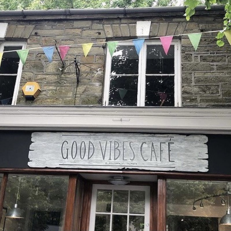 Cafe exterior with Good Vibes Cafe sign and bunting