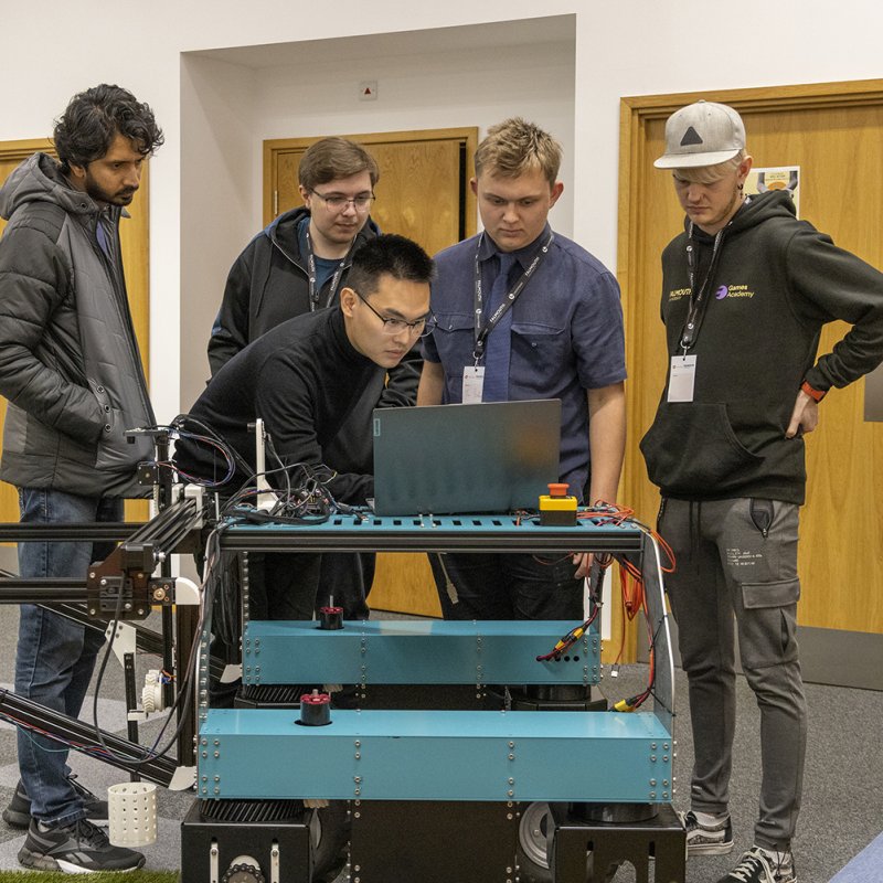 Students examining daffodil picking robot