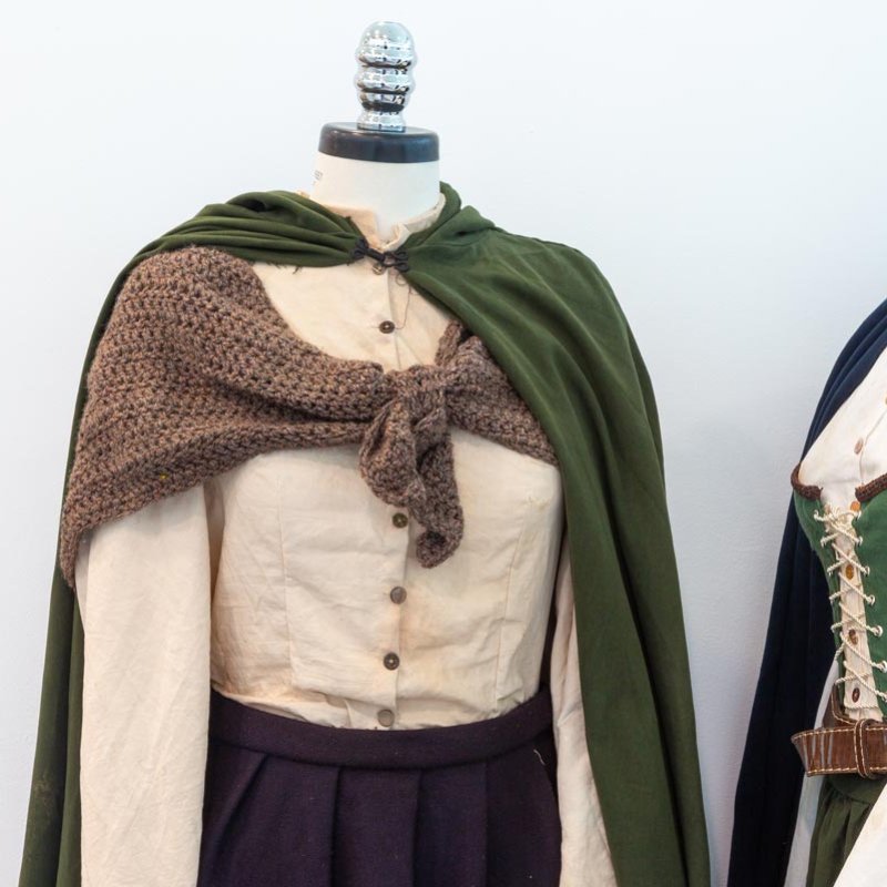 Two mannequins dressed in medieval style dresses and cloaks
