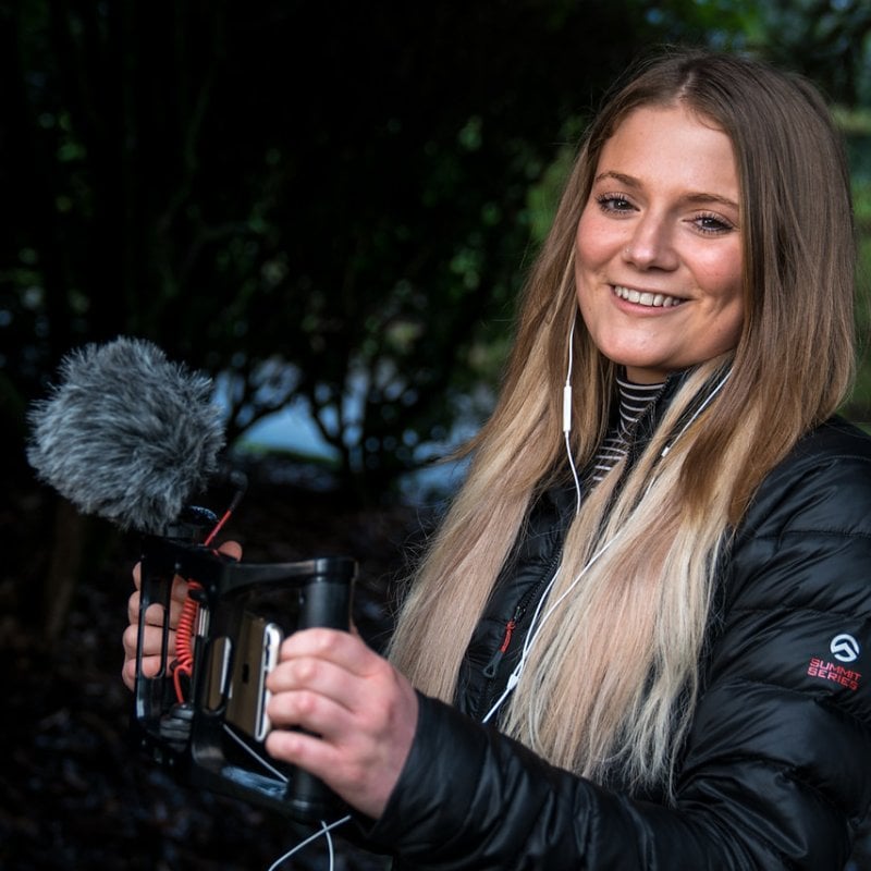 Journalism student Hannah Newton holding a camera