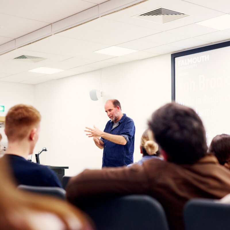 Xan Brooks delivering a lecture to Falmouth University students who are seated