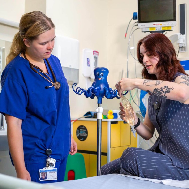 A Falmouth University student showing a healthcare professional her Octopus IV drip design 