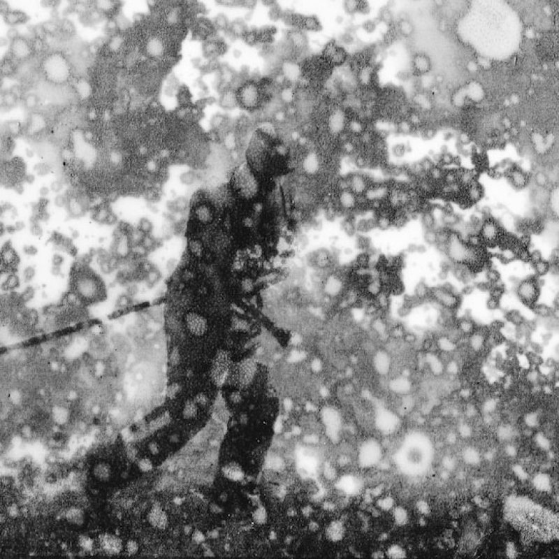 Analogue photograph of a man pulling a hose