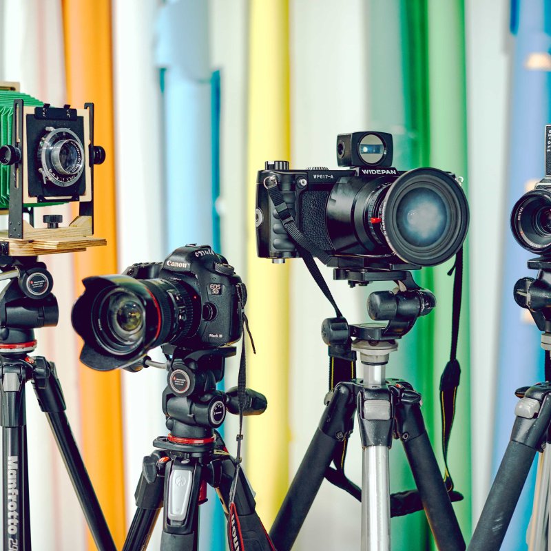 Set of 4 different types of cameras on tripods