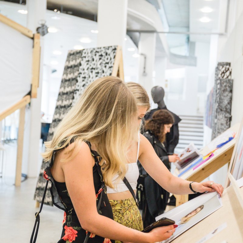 Students looking at work at the Falmouth Showcase