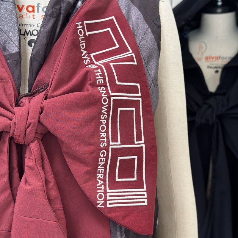A maroon jacket on a mannequin