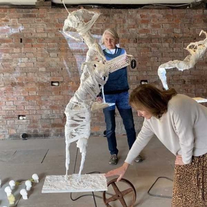 Audience members interacting with a sculpture