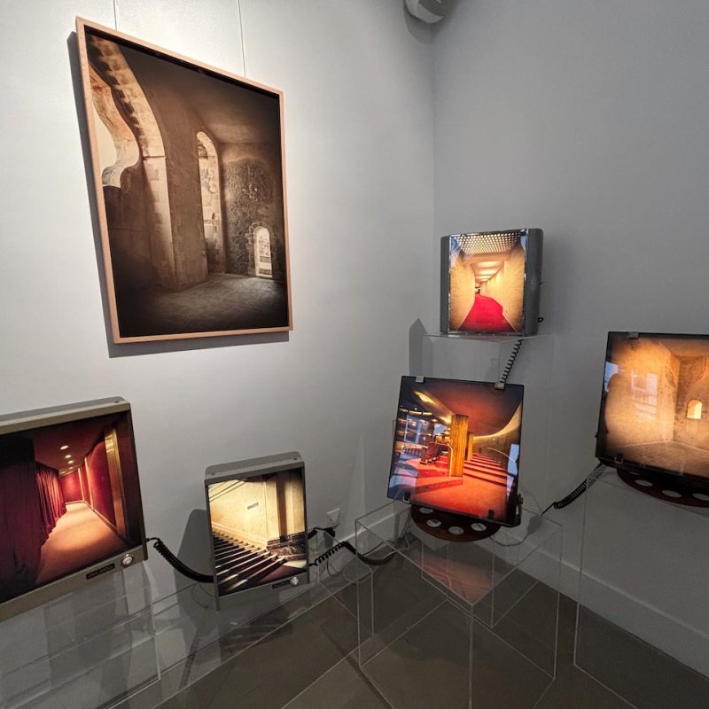 Multiple screens displaying architectural photographs of stone walls and stairs