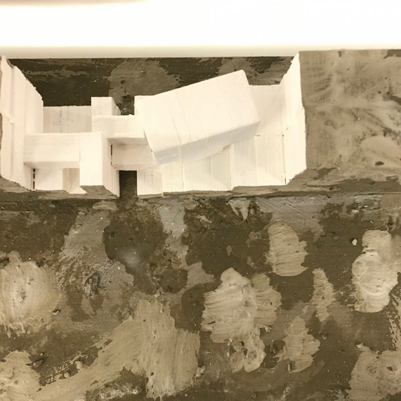 Physical model of a building painted in whites and greys