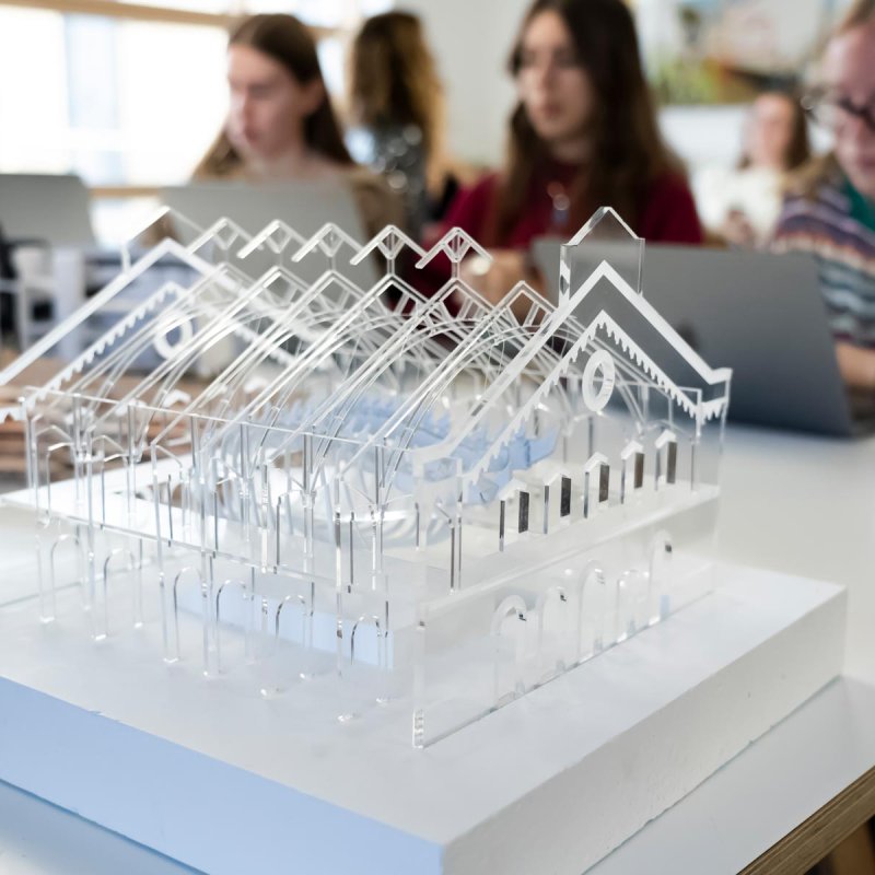 Clear plastic model of a building with a pitched roof