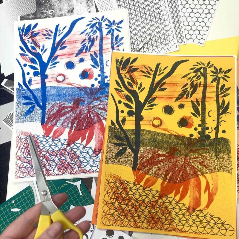 aerial view of Risograph prints with hand and scissors