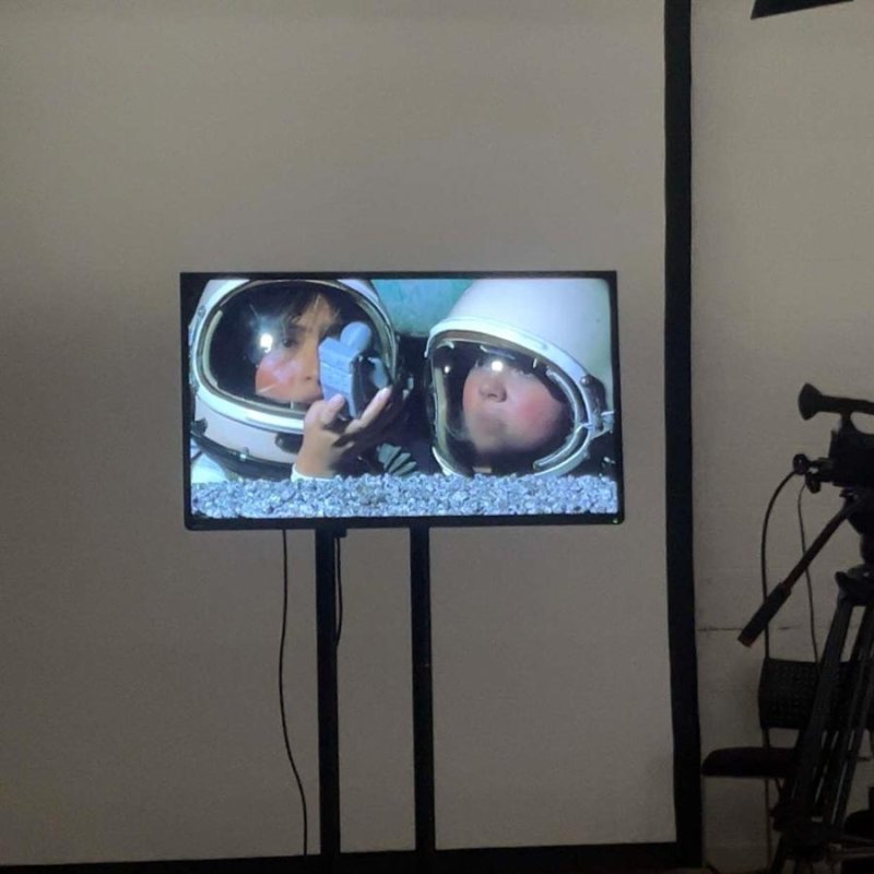 Digital screen of two people wearing astronaut helmets