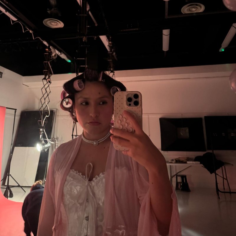 A Theatre & Performance taking a selfie wearing rollers in her hair