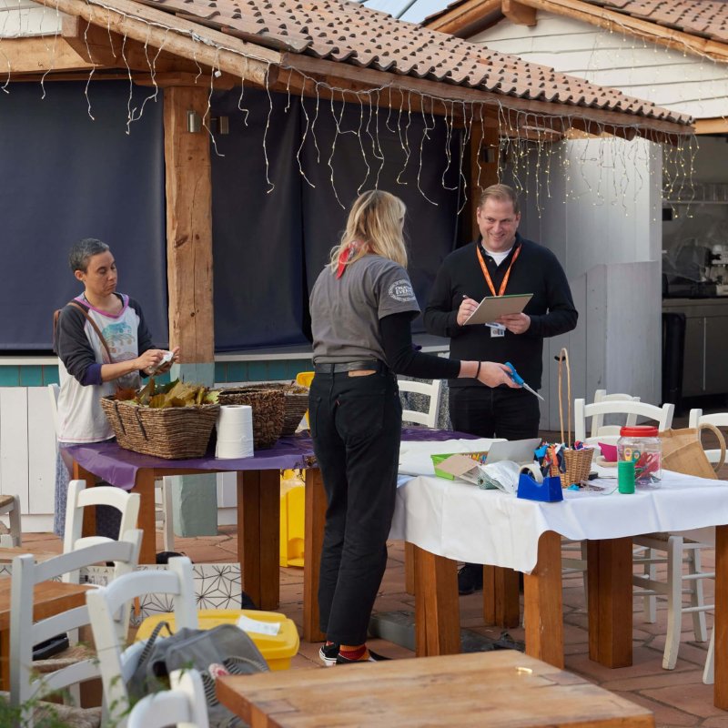 A Sustainable Festival Management student and tutor setting up a stall