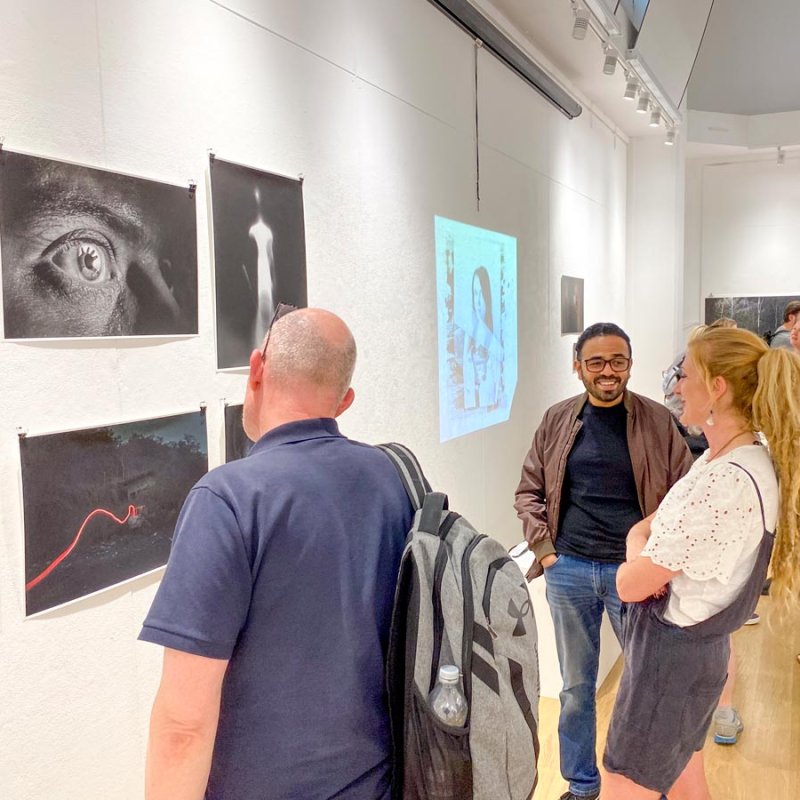 People looking at work in the Landings exhibition