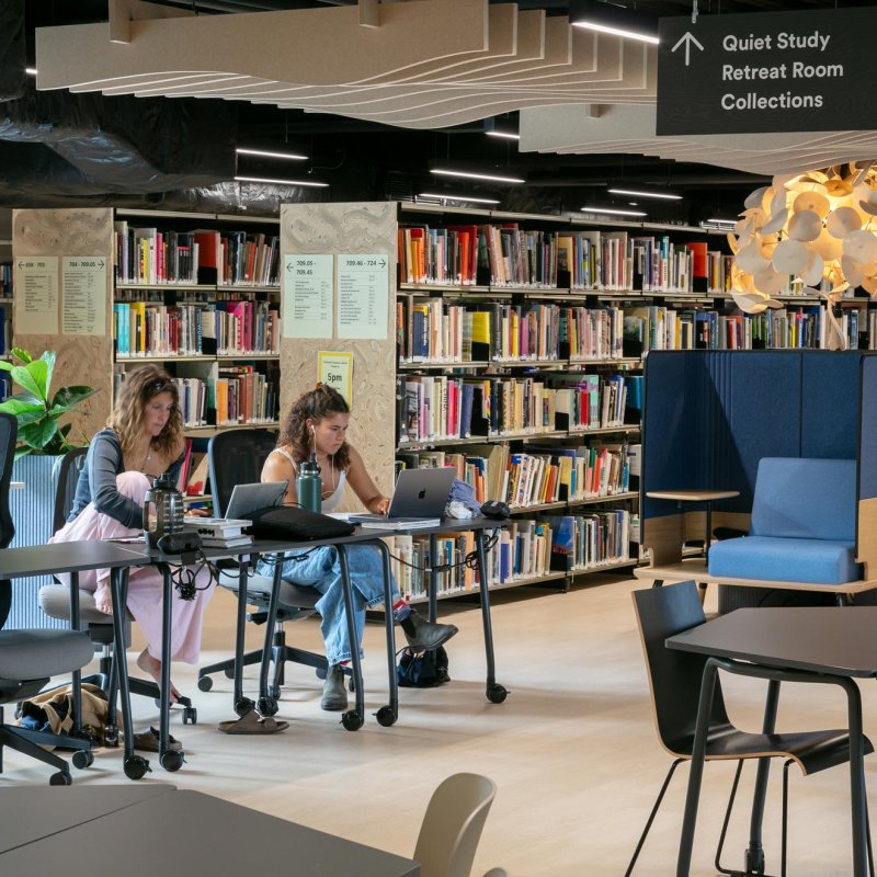 Two Falmouth University students in the Falmouth Campus library