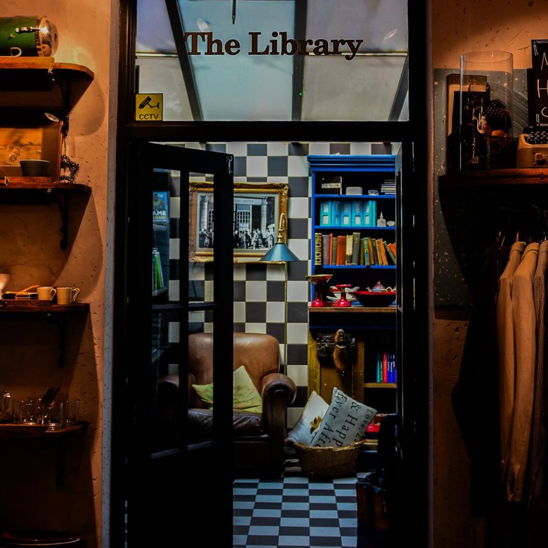 View of a doorway into a shop with 'The Library' written above the door