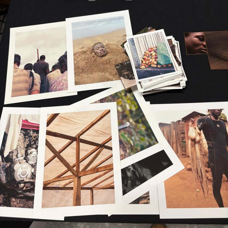 A selection of printed photographs laid out on a table