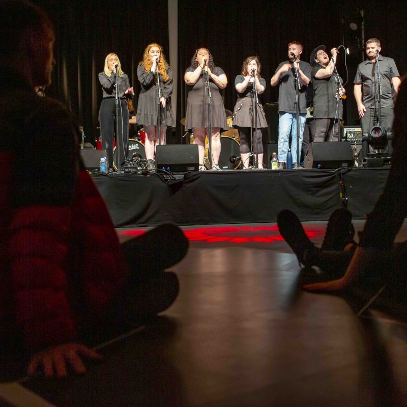 Singing group performing at LAAA research event