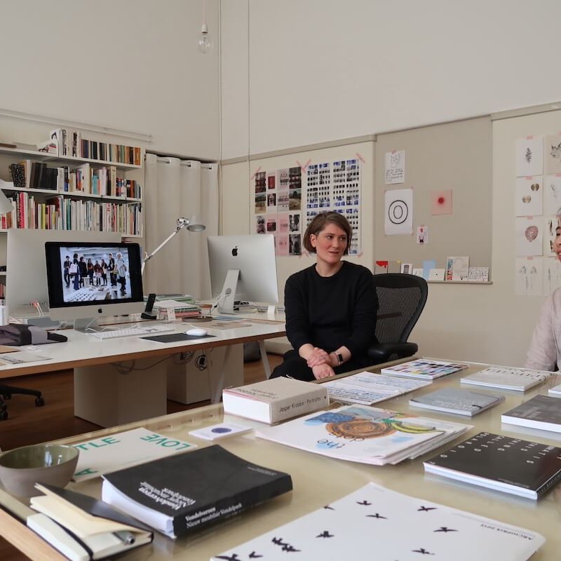 Two females in design studio in Amsterdam surrounded by design work and books