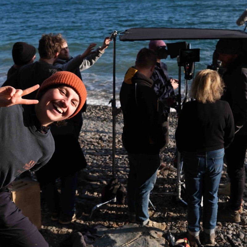 Group of people filming on beach