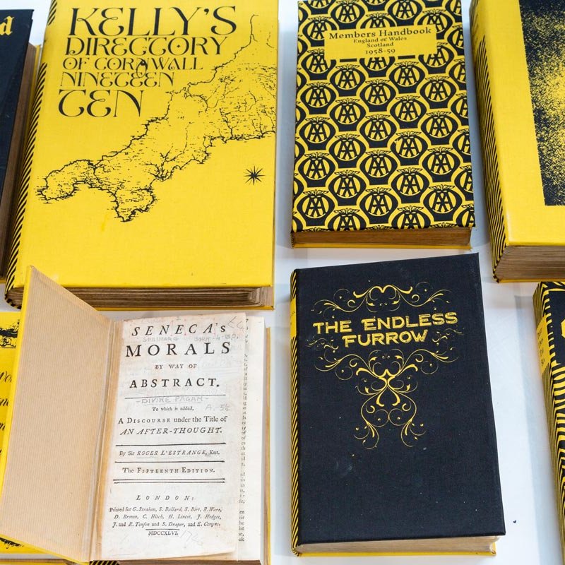 Black and yellow book covers on a table