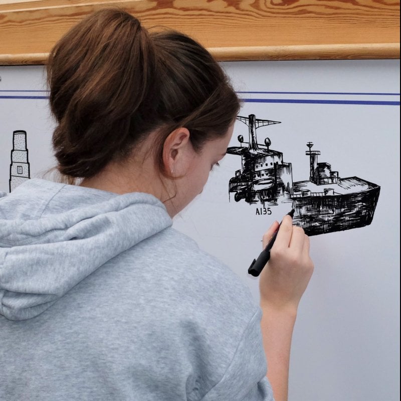 Falmouth student adding to Red Bull Doodle Art mural