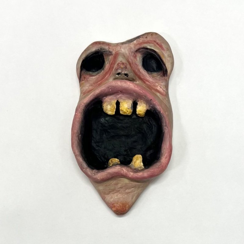 Miniature sculpture of monstrous face