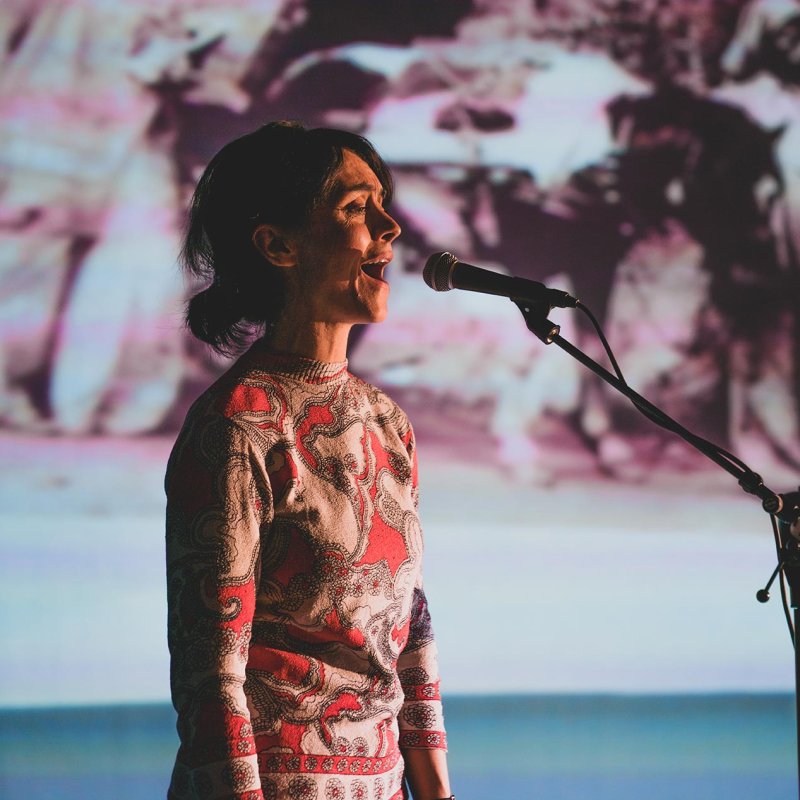 A woman singing into a microphone