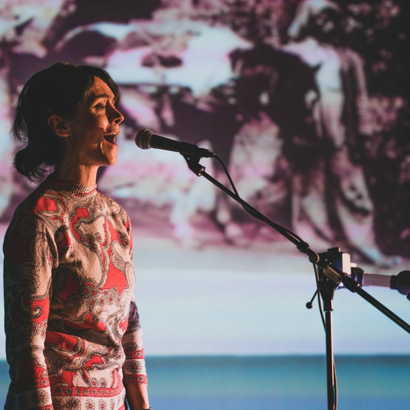 A woman singing into a microphone