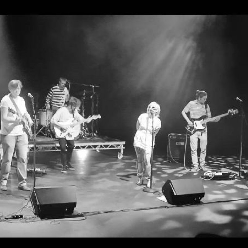A band perform on stage in black and white 