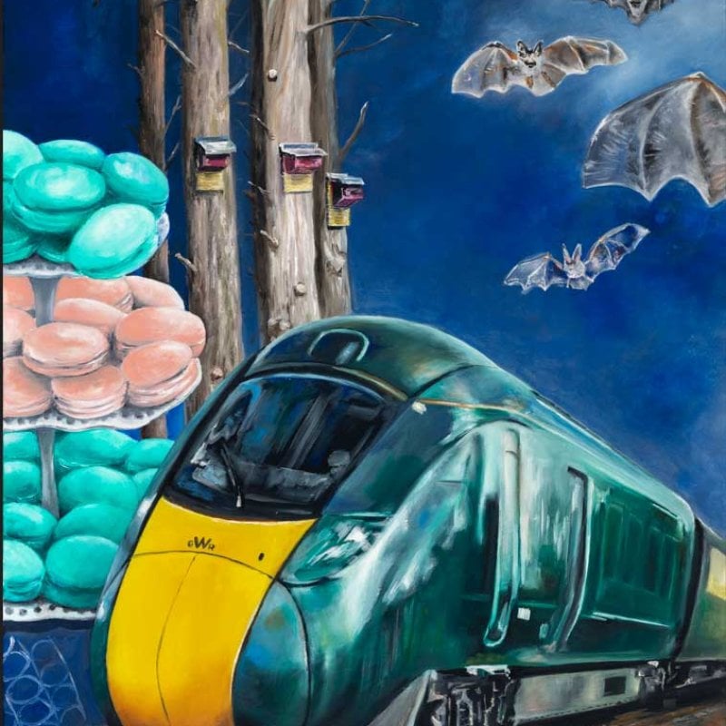 Mural of a green train with trees, bats and macarons in background