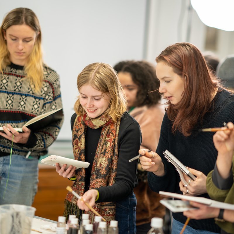 Students painting in a workshop at Falmouth Illustration Festival 