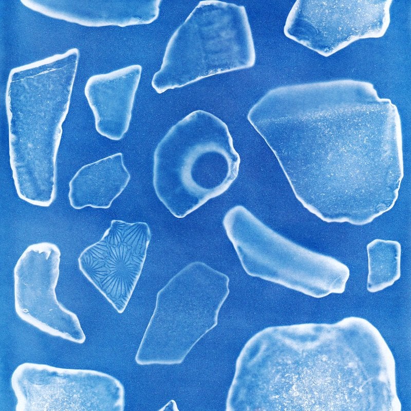 A microscopic view of unidentified fragments on a blue background