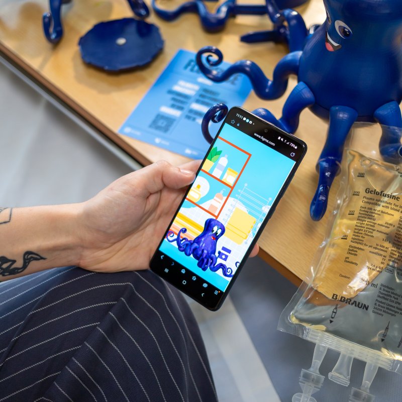 Image of person holding a mobile phone showing an app screen