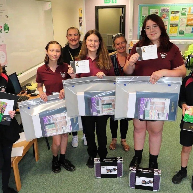 Five children and two teachers holding portfolios and their postcards