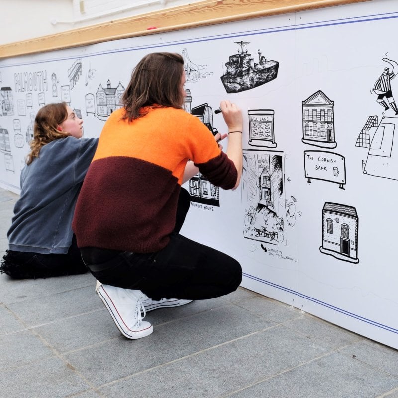 Two Falmouth students creating mural with Dave Draws for Red Bull Doodle Art